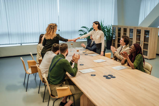 istock Businesswomen shaking hands across the table 1449664057