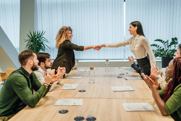 istock Businesswomen shaking hands across the table 1449664096