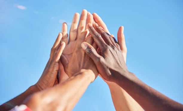 high five, sports and team with support, motivation and solidarity during a game with a blue sky. group of people, athlete friends or men with hands together for a win, success and partnership - sports team team teamwork togetherness imagens e fotografias de stock