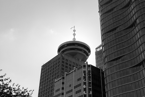 Vancouver BC, Canada- October 11, 2022: Black and white sunlight shining behind the Vancouver Harbour Centre Lookout tower Observation Deck located in downtown Vancouver BC
