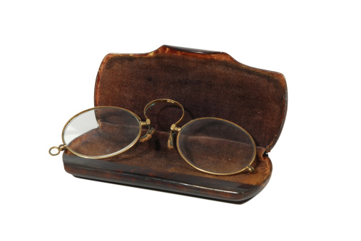 antique vintage oval pince-nez spectacles and tortoiseshell case, isolated on white