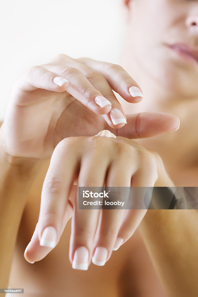 applying hand lotion closeup of female hands applying hand cream Hand Cream Stock Photo