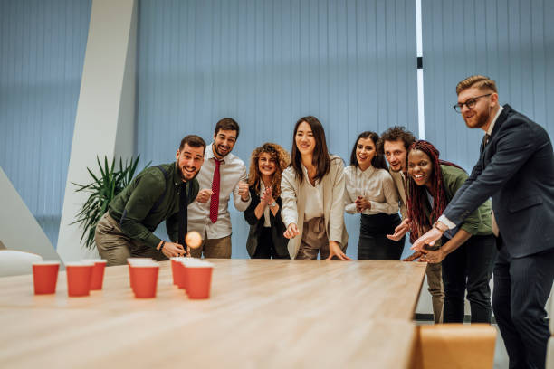 istock Young colleagues playing beer pong 1449670028