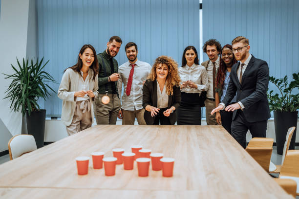 istock Young colleagues playing beer pong 1449670126