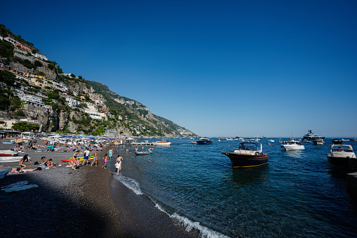Excursion cruise boats and ships with tourists on Tyrrhenian sea, Amalfi coast, Positano, Italy.
