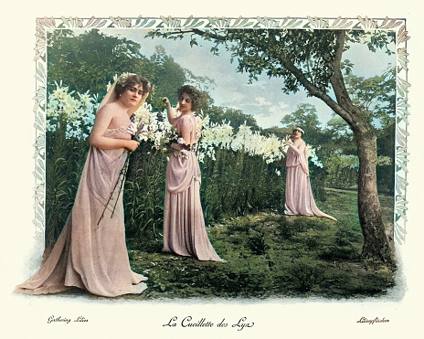 Vintage victorian photograph of women in neo-classical dress gathering lilies in the field, french, 19th Century.