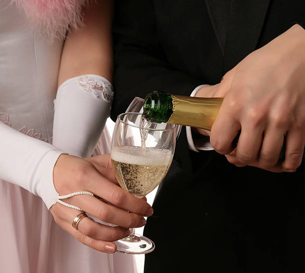 The two hands with a bootle of champagne