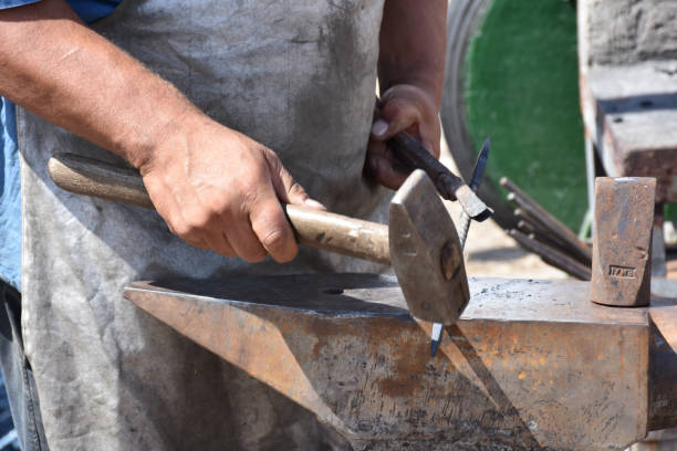 istock Blacksmith forged ironsmith. traditional hammer beating 1449681235
