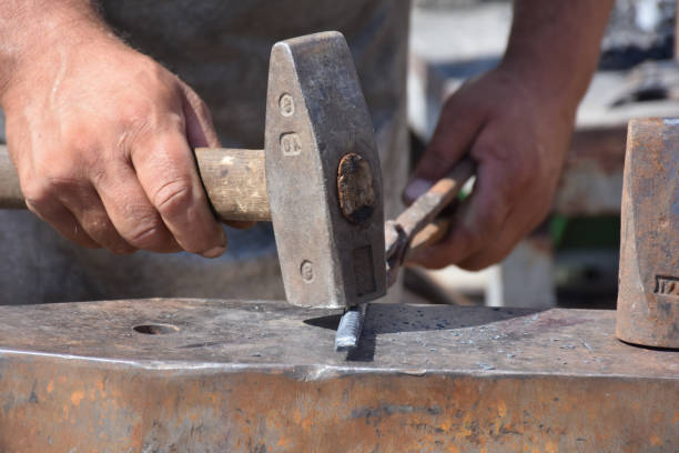 istock Blacksmith forged ironsmith. traditional hammer beating 1449681727