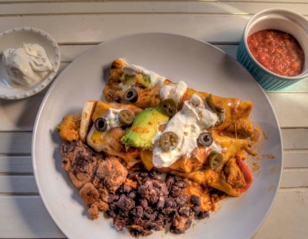 Top View of Chicken Enchiladas on white Natural wood surface stock photo