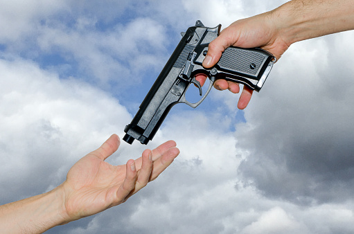 God's Hand giving handgun to Adam. This represents the right to Adam to make the law and order on Earth.