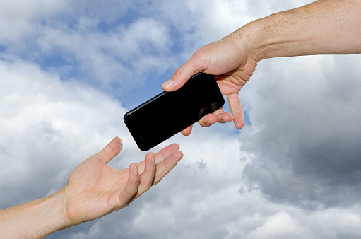 God's Hand giving mobile phone to Adam. This represents the knowledge to Adam of technology and communication