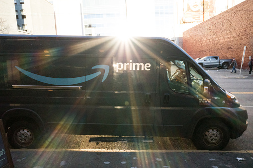 Seattle, USA - Dec 16, 2022: Late in the day an Amazon prime delivery van in downtown.