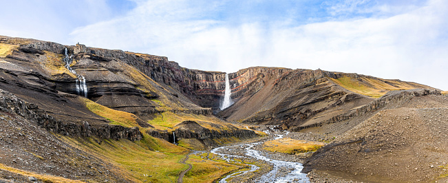 Hengifoss is the third highest waterfall in Iceland, 128 meters. It is located in Hengifossá in Fljótsdalshreppur, East Iceland. It is surrounded by basaltic strata with thin, red layers of clay between the basaltic layers.