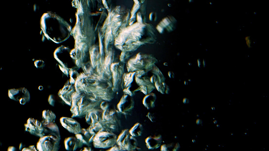 Black background. Shooting underwater. Stock footage. Impulsively moving bubbles of pure water and floating different particles. High quality FullHD footage