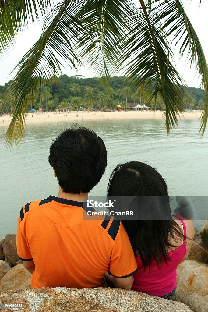 Lovers Under Palm Tree Couple enjoying their time at the island. Adult Stock Photo