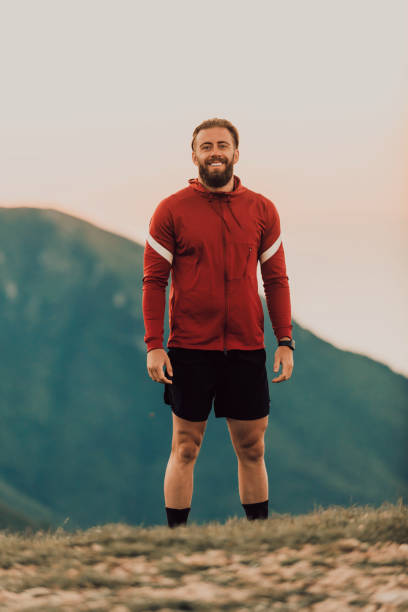istock An athlete rests on top of a mountain after exhausting running training 1449696903