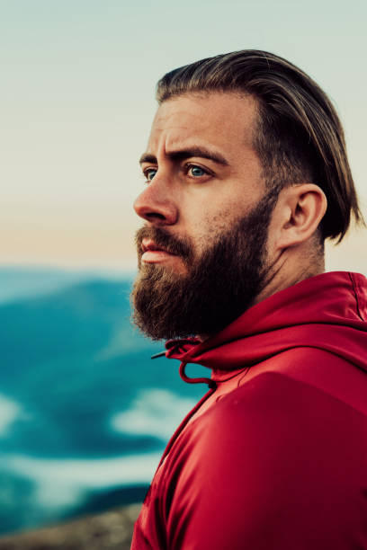 istock An athlete rests on top of a mountain after exhausting running training 1449696922