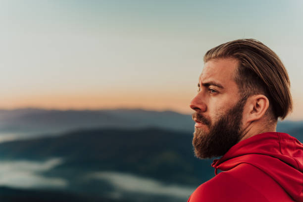 istock An athlete rests on top of a mountain after exhausting running training 1449696924