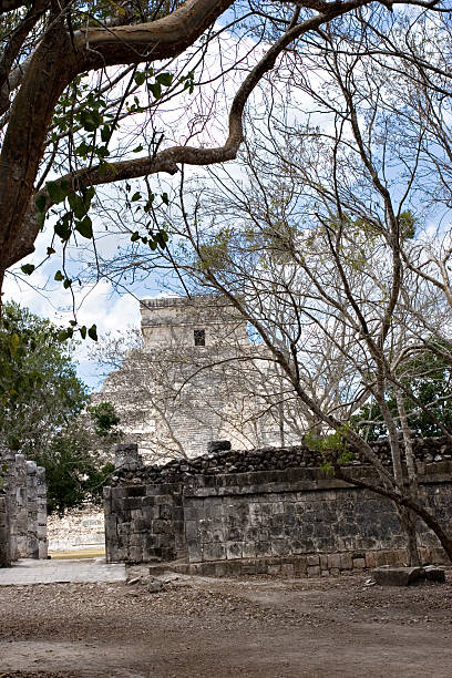 Chichen Itza pyramid viewed through the trees. stock photo