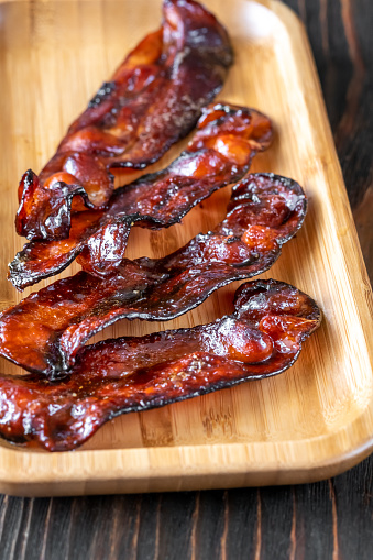 Fried bacon strips glazed in brown sugar