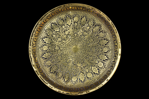 Small round brass tray with a pattern