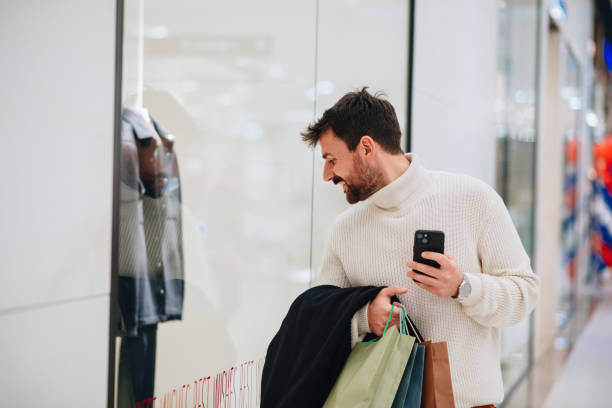 istock Smiling young man on a shopping spree 1449703961