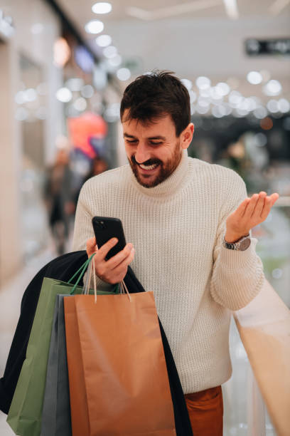 istock Man surprised about how much money he saved shopping on Black Friday 1449704397
