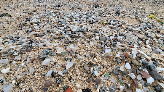 Pieces of dead bleached coral reef washed out on a beach after coral bleaching event on Mahe Island, Seychelles.