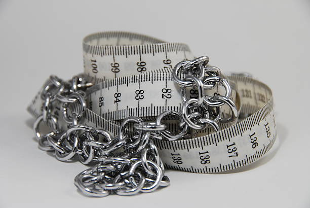 Tape measure in chains stock photo