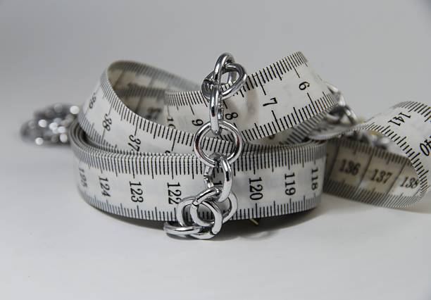 Measuring tape in chains stock photo