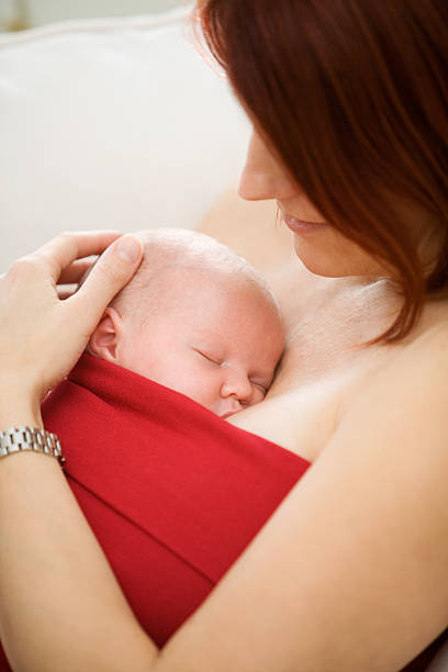 istock A new born baby being help tight by his mother 144971187