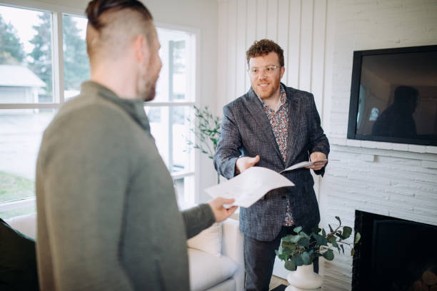 istock Real Estate Agent Handing Document to Client 1449711919