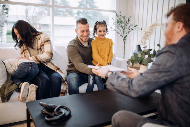 Real Estate Agent Signing Documents With Buyers