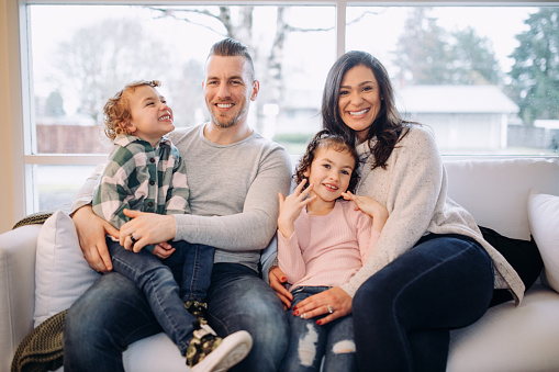 A cozy time together on a cold winter day for a multi-ethnic family at home during the holidays.