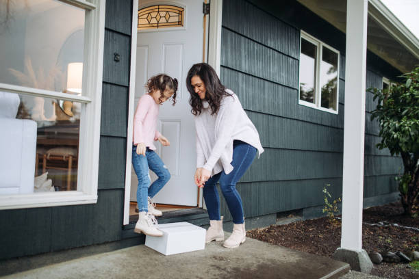 istock Mother and Daughter Pick Up Package Delivery 1449712880