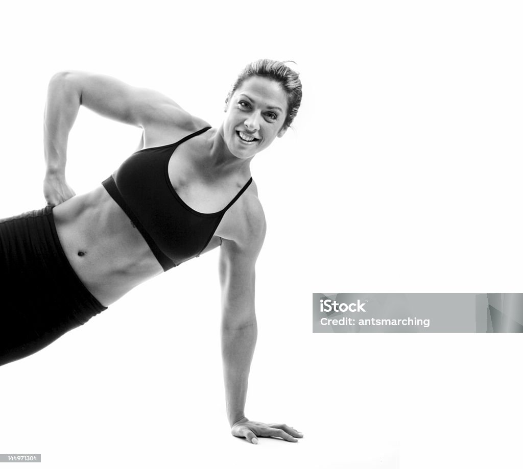 Strength Female bodybuilder demonstrating her strength Abdomen Stock Photo