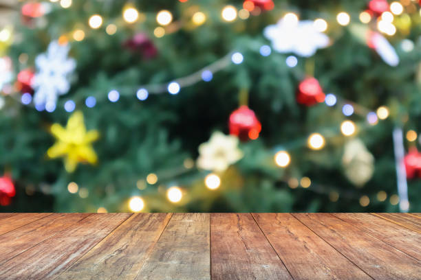 istock Empty wood table top with blur Christmas tree with bokeh light background 1449718078