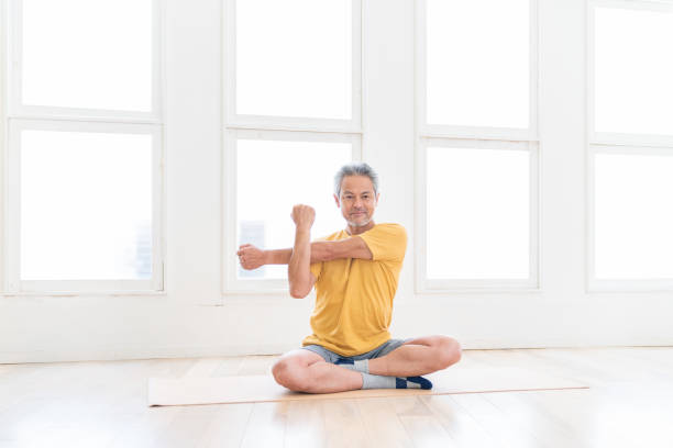 istock elderly man exercising in the room 1449733946