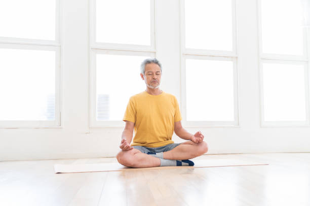 istock elderly man exercising in the room 1449733975