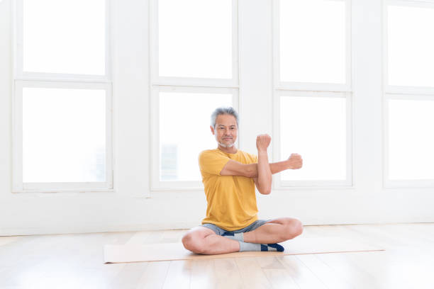 istock elderly man exercising in the room 1449734076