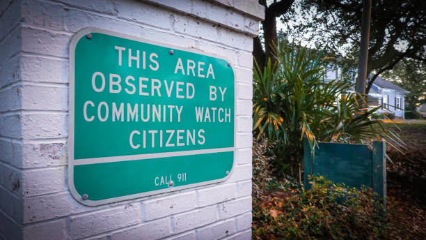 Community Watch Sign A neighborhood community watch sign warns potential intruders. neighborhood crime watch stock pictures, royalty-free photos & images