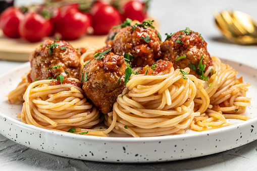 Close-up of Italian pasta with tomato sauce and meatballs. Restaurant menu, dieting, cookbook recipe top view.
