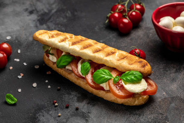 istock Pressed and toasted panini caprese with tomato, mozzarella and basil, Caprese Panini Sandwich. Delicious breakfast or snack, Clean eating, dieting, vegan food concept. top view 1449737568