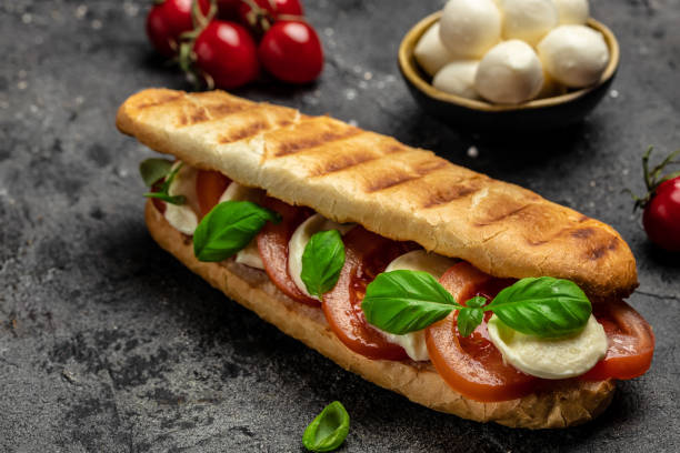 istock Healthy Grilled Basil Mozzarella Caprese Panini Sandwich. Delicious breakfast or snack, Clean eating, dieting, vegan food concept. top view 1449737579
