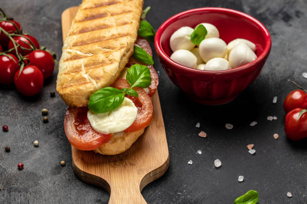 istock Pressed and toasted panini caprese with tomato, mozzarella and basil, Caprese Panini Sandwich. Delicious breakfast or snack, Clean eating, dieting, vegan food concept. top view 1449737611