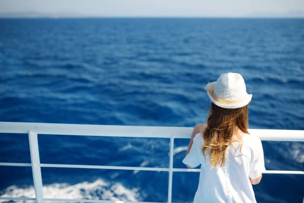 Adorable young girl enjoying ferry ride staring at the deep blue sea. Child having fun on summer family vacation in Greece. Adorable young girl enjoying ferry ride staring at the deep blue sea. Child having fun on summer family vacation in Greece. Kid sailing on a boat. ferry deck girls stock pictures, royalty-free photos & images