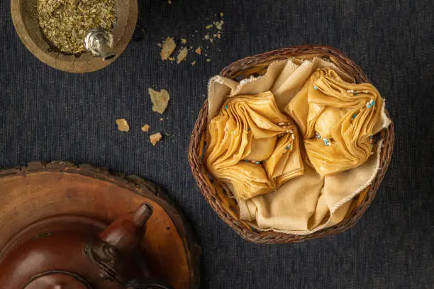 Top view of fried pastries stuffed with sweet potato or quince with yerba mate and a kettle. Typical Argentine food.