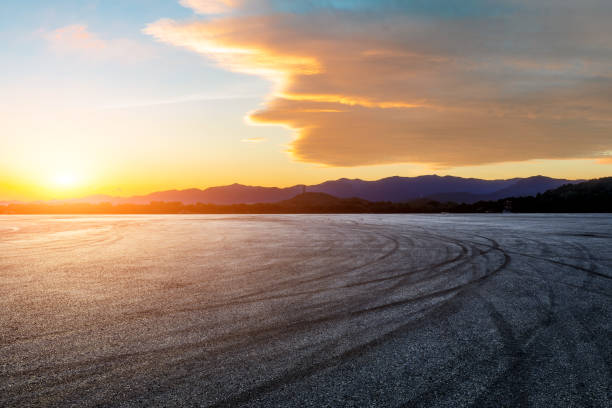 istock Asphalt road and mountains at sunset 1449754123