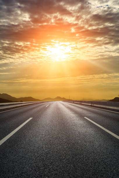 istock Asphalt road with sky clouds at sunset 1449754993